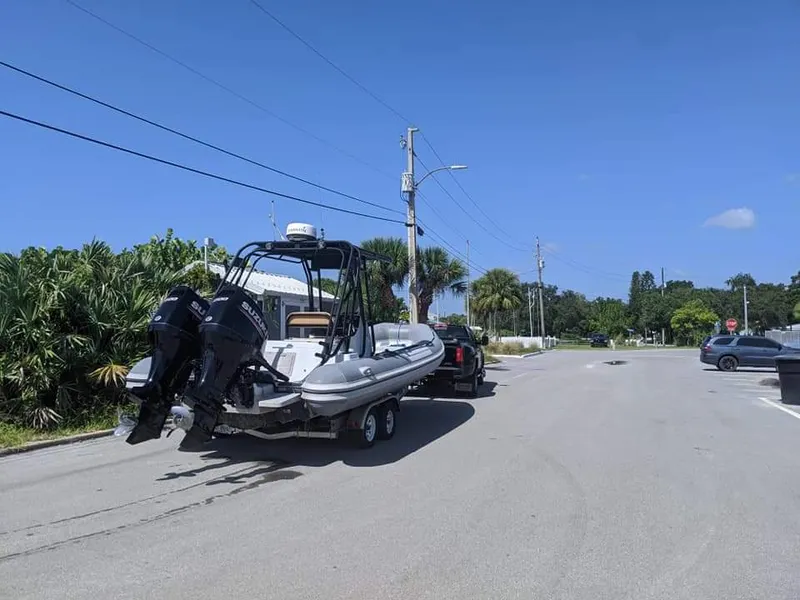 Slide: The Image of Nautica WIDE BODY 2005 boat with open storage, in front of red building. - 3