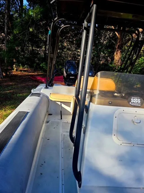 Slide: The Image of Nautica WIDE BODY 2005 boat with outboard motor parked outdoors. - 6