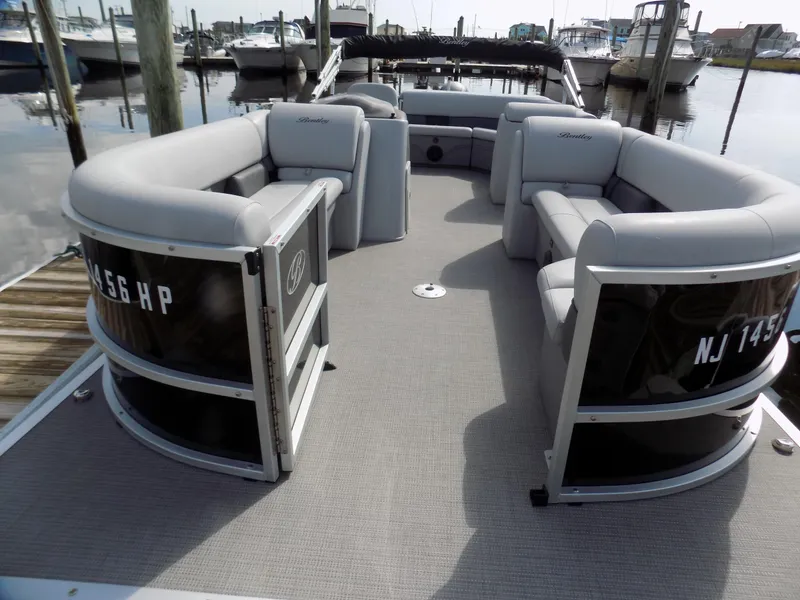 Slide: The Image of 2021 Bentley Pontoons 240 CRUISE with spacious seating, docked at a marina. - 3