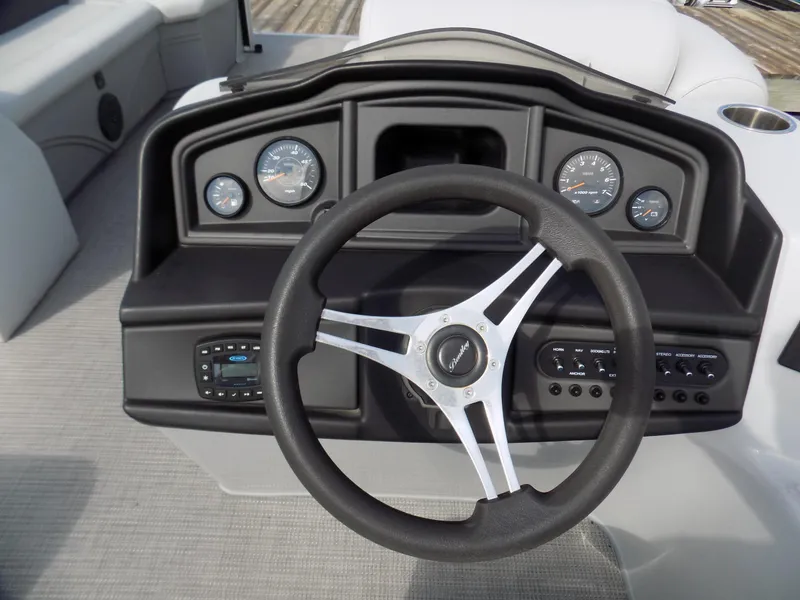 Slide: The Image of 2021 Bentley Pontoons 240 CRUISE dashboard with steering wheel and gauges. - 8