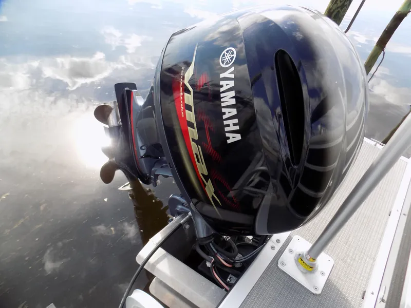 Slide: The Image of Yamaha outboard motor on 2021 Bentley Pontoons 240 CRUISE, reflecting on calm water. - 9