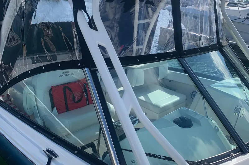 Slide: The Image of 2022 Cobia 240 DC boat interior with seating and clear canopy. - 12
