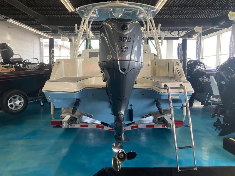 Slide: The Image of 2022 Cobia 240 DC boat with Yamaha 300 engine displayed indoors. - 15