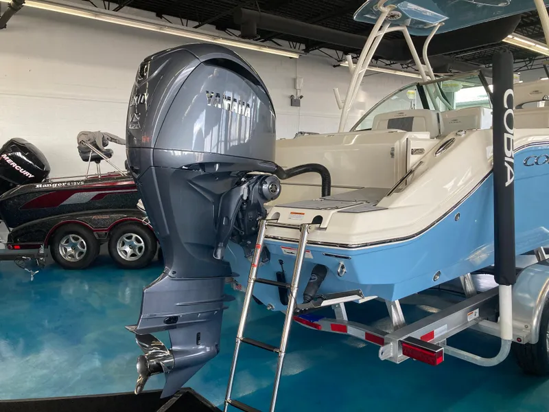Slide: The Image of 2022 Cobia 240 DC boat with Yamaha outboard motor in showroom. - 16