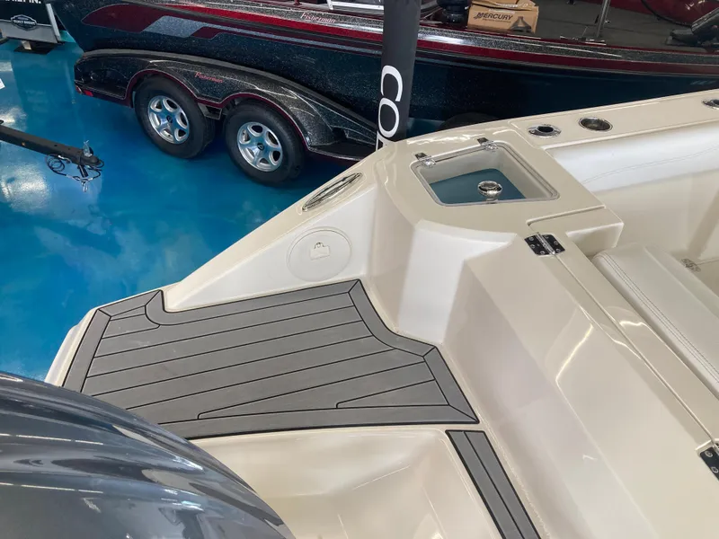 Slide: The Image of 2022 Cobia 240 DC boat interior with sleek design and modern features, displayed in a showroom. - 22