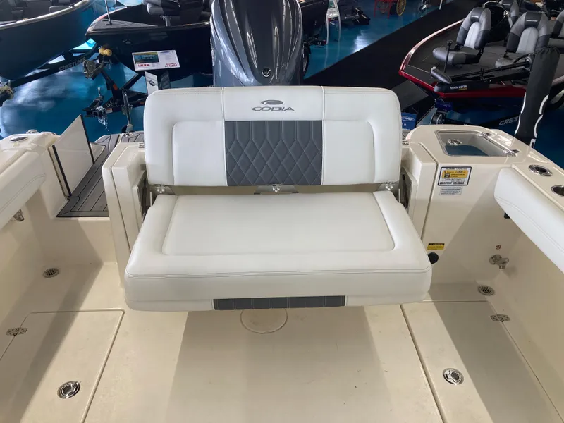 Slide: The Image of 2022 Cobia 240 DC boat interior with cushioned seating and modern design. - 26