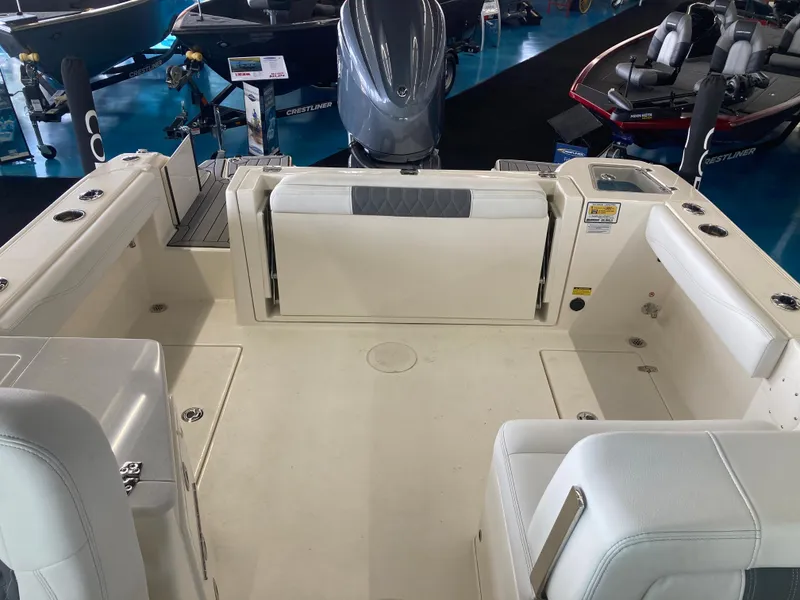 Slide: The Image of 2022 Cobia 240 DC boat interior with spacious seating and storage. - 27