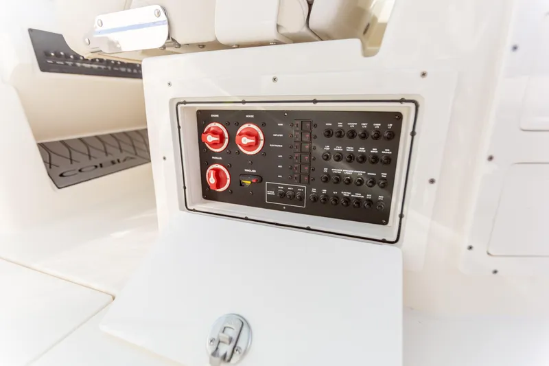Slide: The Image of Control panel of 2022 Cobia 240 DC boat, featuring switches and dials. - 41