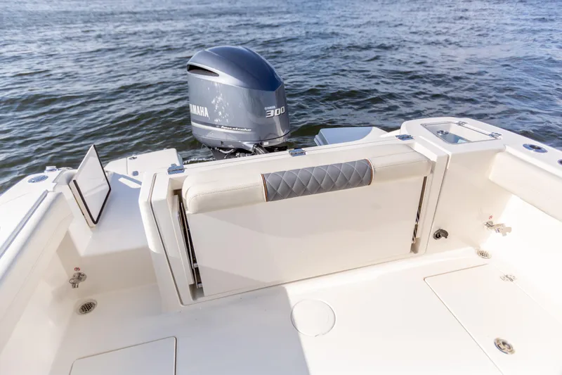 Slide: The Image of 2022 Cobia 240 DC boat with Yamaha 300 engine on water. - 47