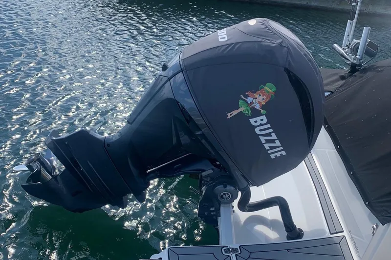 Slide: The Image of Outboard motor on 2022 Cobia 240 DC boat, featuring "BUZZIE" graphic. - 6