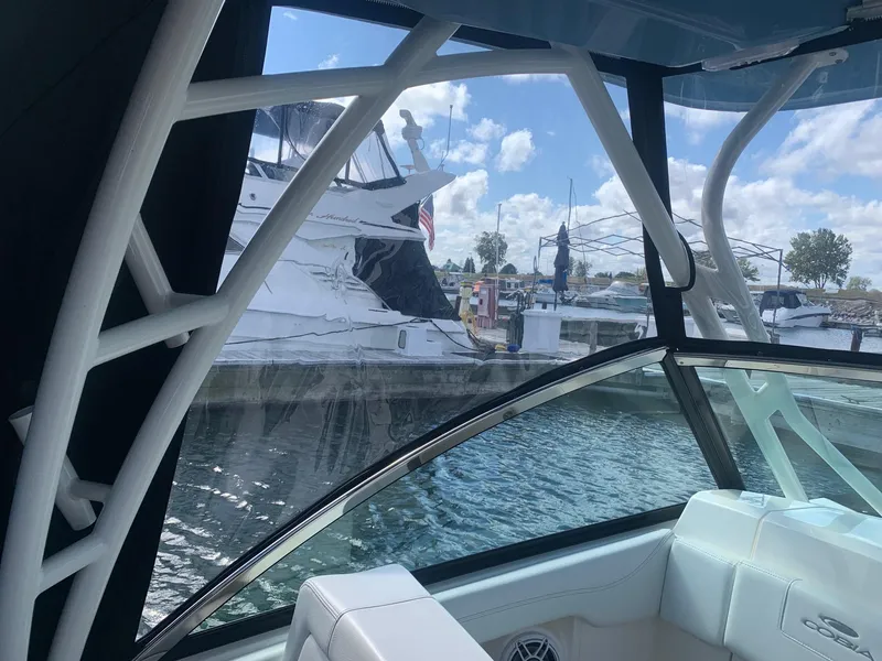Slide: The Image of Interior view of a 2022 Cobia 240 DC boat docked at a marina. - 9