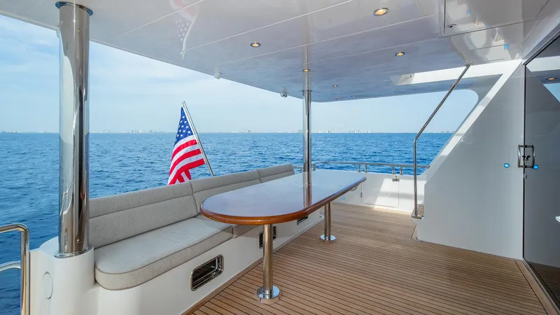 Slide: The Image of Hampton 680 ENDURANCE LRC 2027 yacht deck with ocean view and American flag. - 10