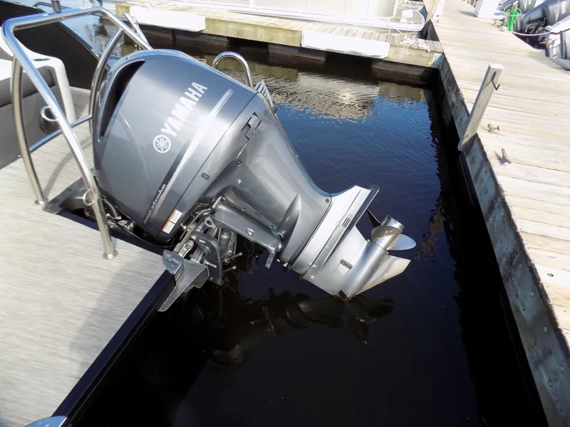 Slide: The Image of 2021 Barletta Corsa 23U with Yamaha outboard motor docked in marina. - 16