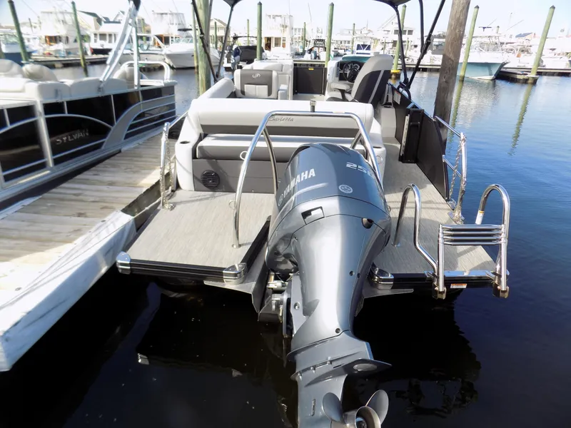 Slide: The Image of 2021 Barletta Corsa 23U pontoon boat with Yamaha outboard motor docked at marina. - 3