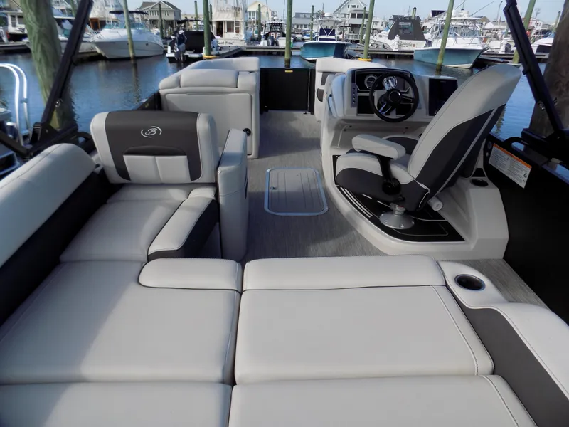 Slide: The Image of 2021 Barletta Corsa 23U boat interior with plush seating and modern helm. - 6