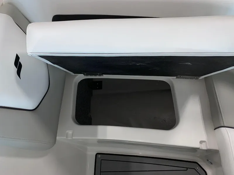 Slide: The Image of 2024 Starcraft SVX 210 boat storage compartment with open cushioned seat. - 10