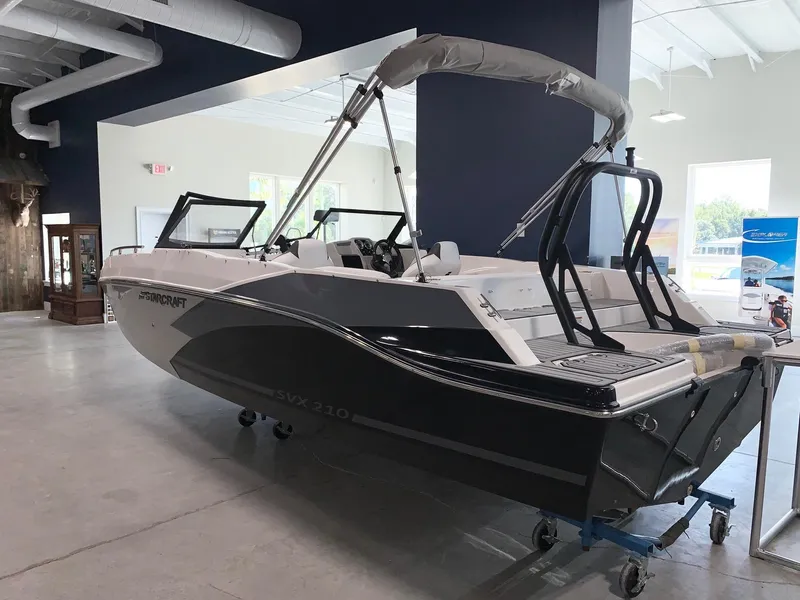 Slide: The Image of 2024 Starcraft SVX 210 boat displayed indoors. - 2
