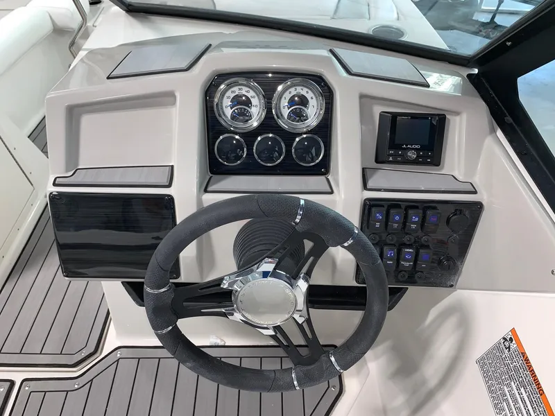 Slide: The Image of 2024 Starcraft SVX 210 boat dashboard with steering wheel and control panel. - 4
