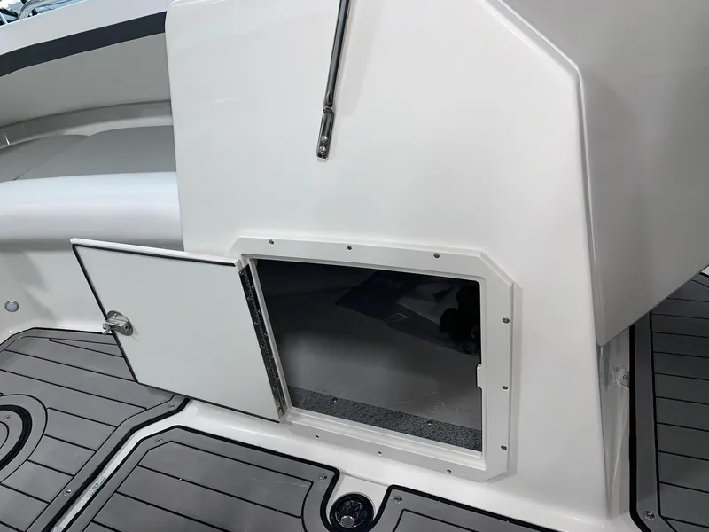 Slide: The Image of 2024 Starcraft SVX 210 boat storage compartment with open door on deck. - 8