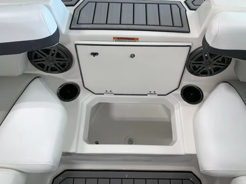 Slide: The Image of 2024 Starcraft SVX 210 boat interior with storage compartment and cup holders. - 9