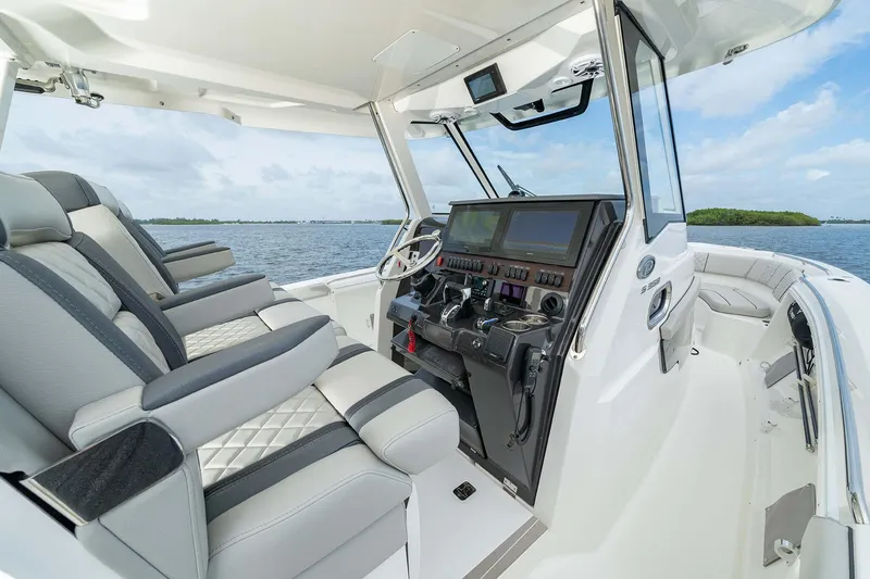 Slide: The Image of 2025 Pursuit S 358 boat interior with modern helm and luxurious seating. - 12