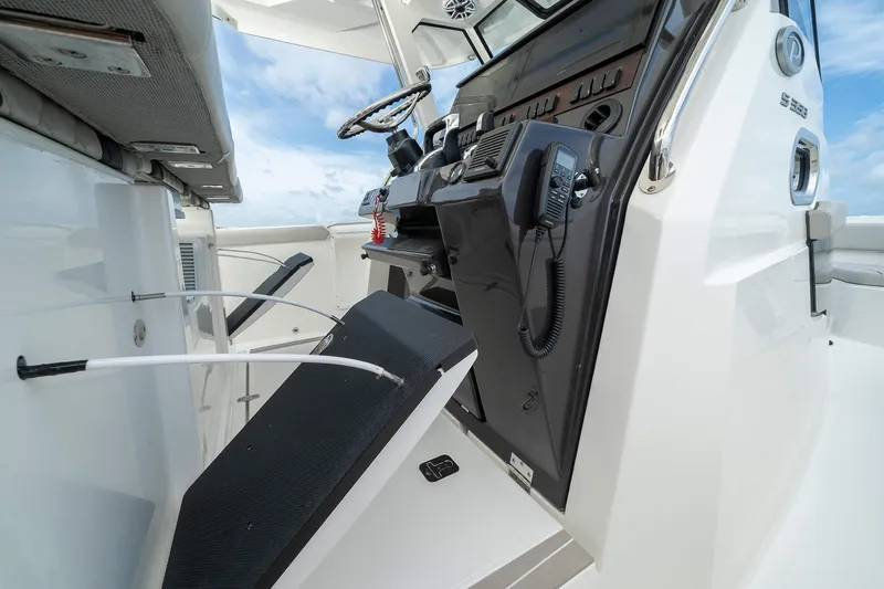 Slide: The Image of 2025 Pursuit S 358 boat helm station with modern controls and seating. - 13