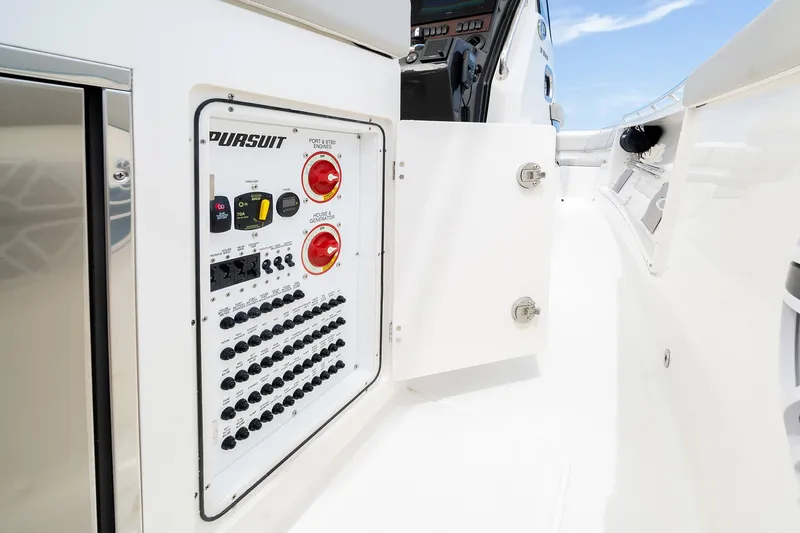 Slide: The Image of Control panel of 2025 Pursuit S 358 boat with open compartment. - 14