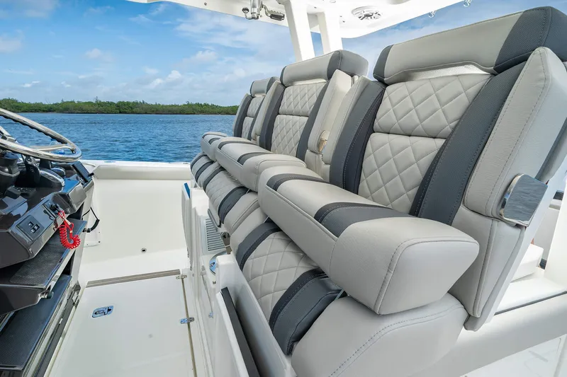 Slide: The Image of 2025 Pursuit S 358 boat interior with luxurious seating and ocean view. - 15