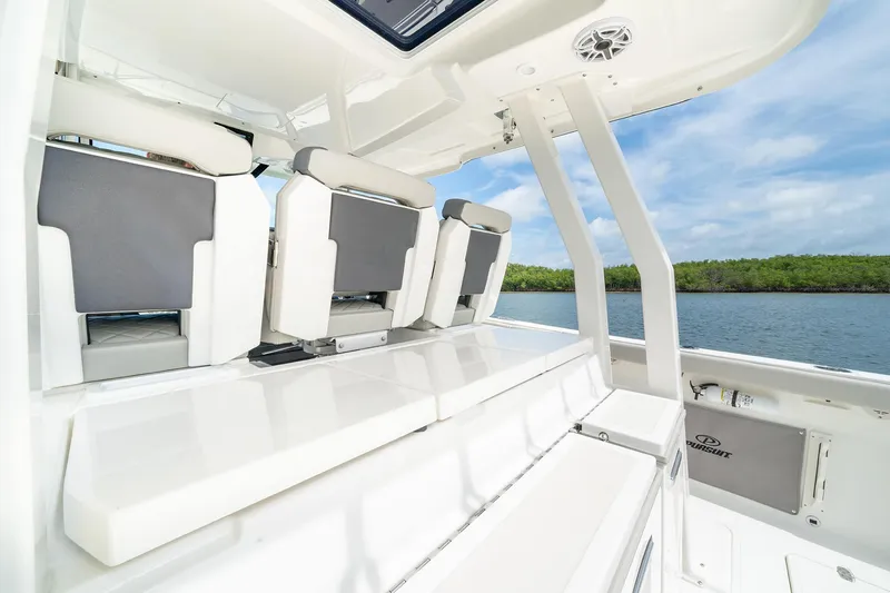 Slide: The Image of 2025 Pursuit S 358 boat interior with seating and scenic water view. - 16
