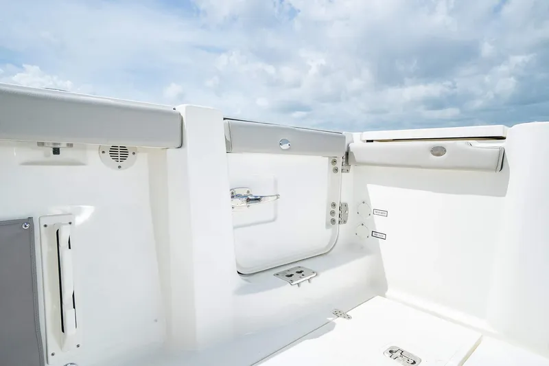 Slide: The Image of 2025 Pursuit S 358 boat interior with white seating and storage compartments. - 20