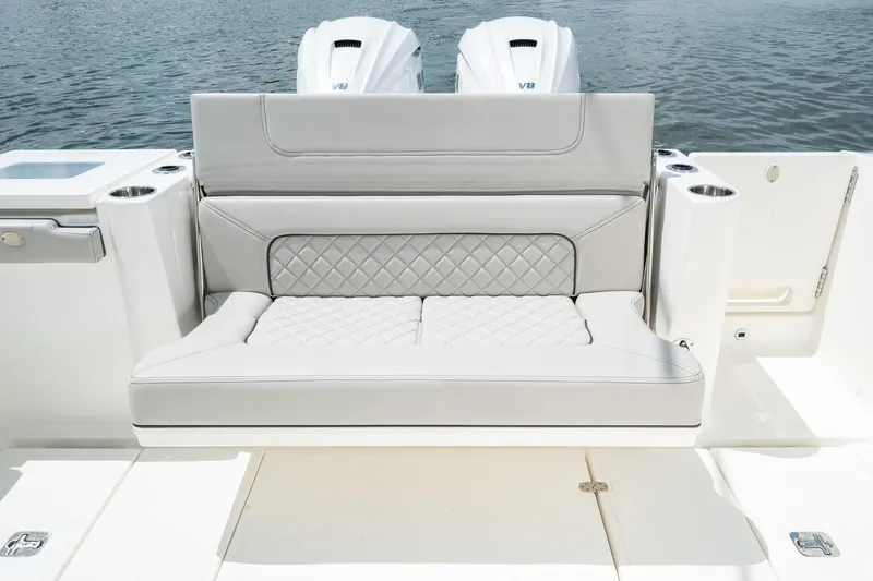 Slide: The Image of Luxury seating on 2025 Pursuit S 358 boat with twin outboard engines. - 23