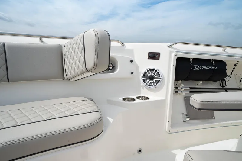 Slide: The Image of 2025 Pursuit S 358 boat interior with cushioned seating and speaker. - 7