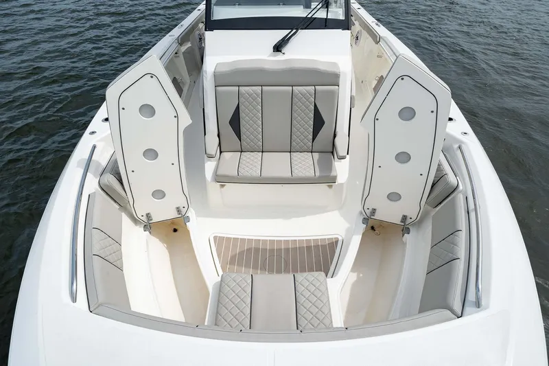 Slide: The Image of 2025 Pursuit S 358 boat interior with cushioned seating and storage compartments. - 8