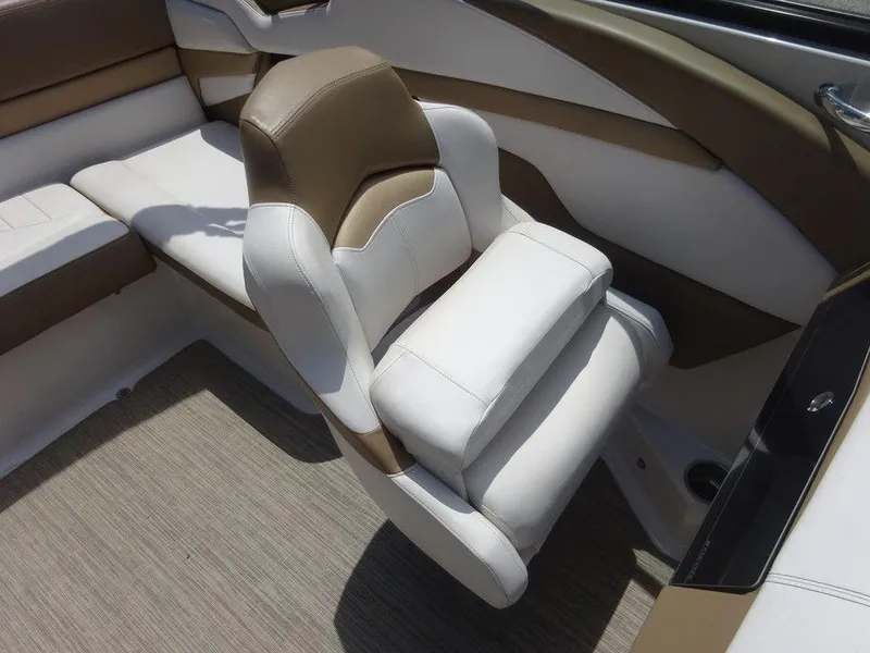 Slide: The Image of 2015 Four Winns Sundowner 235 boat interior with beige and white seating. - 10