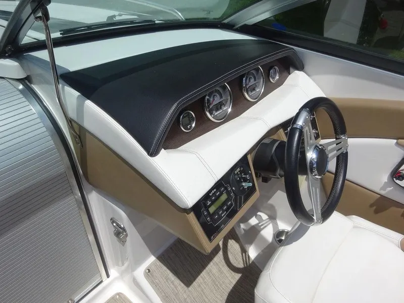 Slide: The Image of 2015 Four Winns Sundowner 235 boat dashboard and steering wheel. - 13