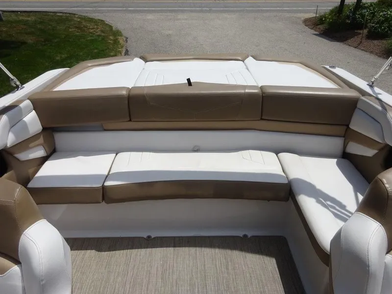 Slide: The Image of 2015 Four Winns Sundowner 235 boat interior with beige and white seating. - 17