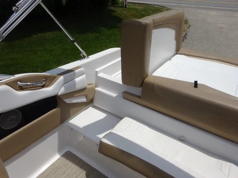 Slide: The Image of Interior seating of 2015 Four Winns Sundowner 235 boat with beige and white upholstery. - 19