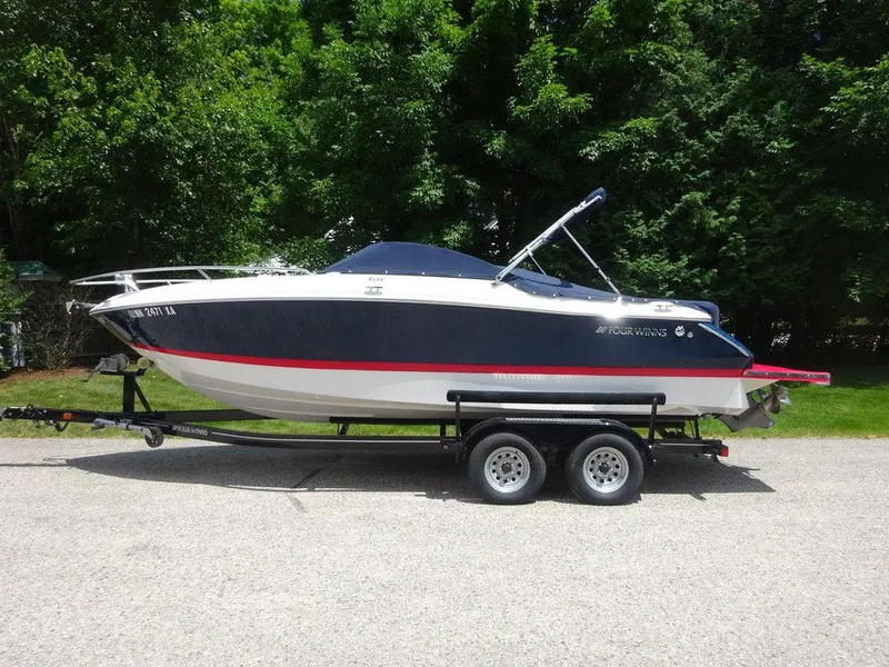 Slide: The Image of 2015 Four Winns Sundowner 235 boat on a trailer, side view. - 23