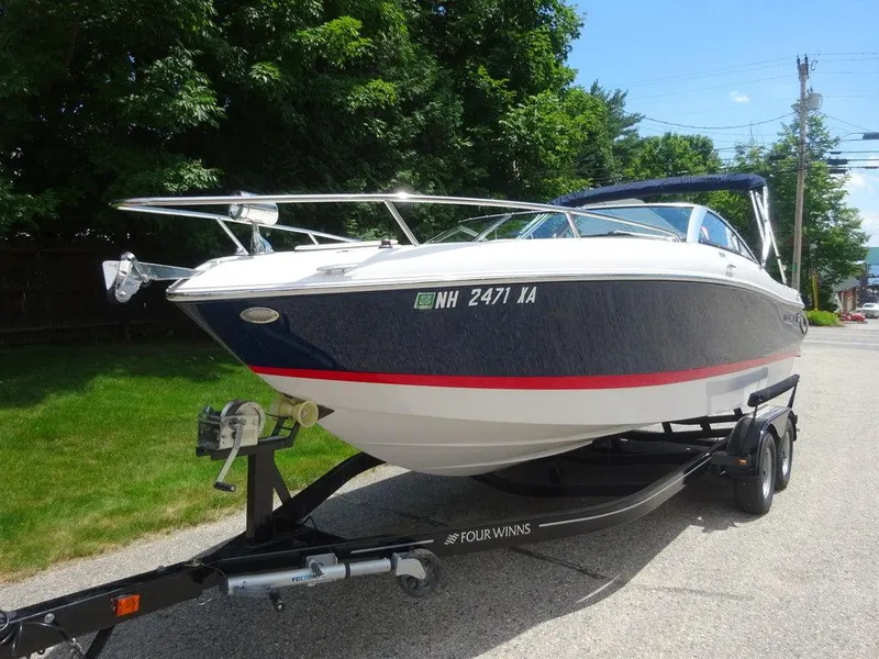 Slide: The Image of 2015 Four Winns Sundowner 235 boat on trailer, parked on a sunny day. - 3