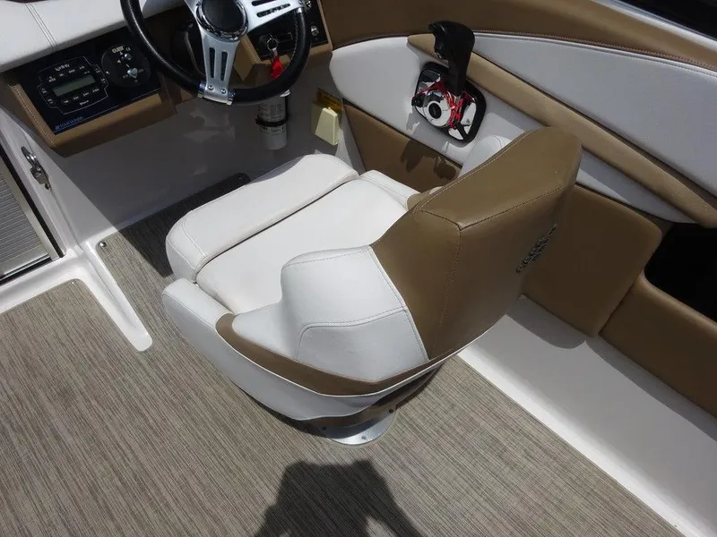 Slide: The Image of 2015 Four Winns Sundowner 235 boat interior with captain's chair and steering wheel. - 5