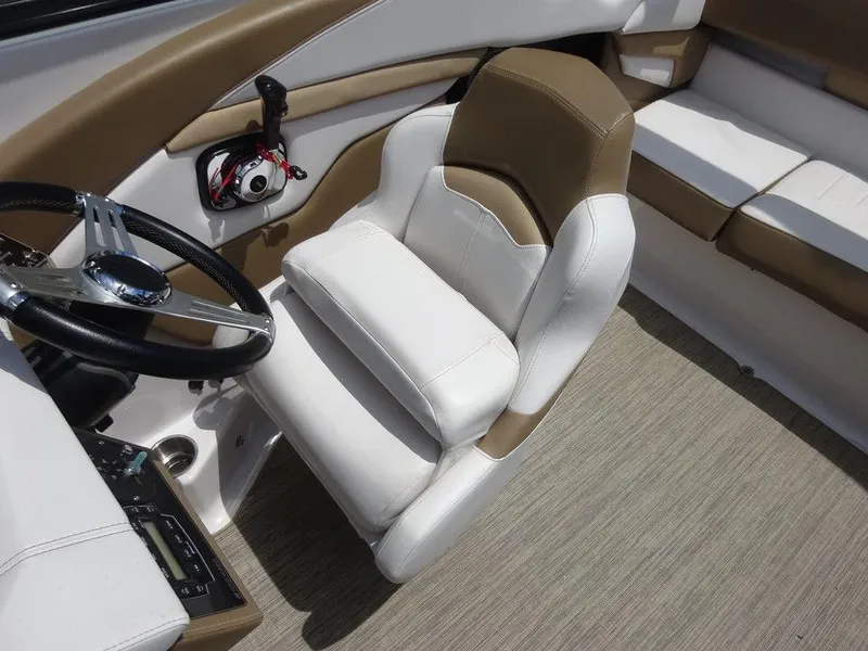 Slide: The Image of 2015 Four Winns Sundowner 235 boat interior with captain's chair and steering wheel. - 8