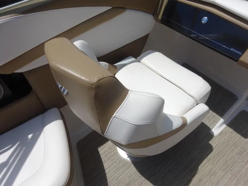 Slide: The Image of 2015 Four Winns Sundowner 235 boat interior with beige and white seating. - 9