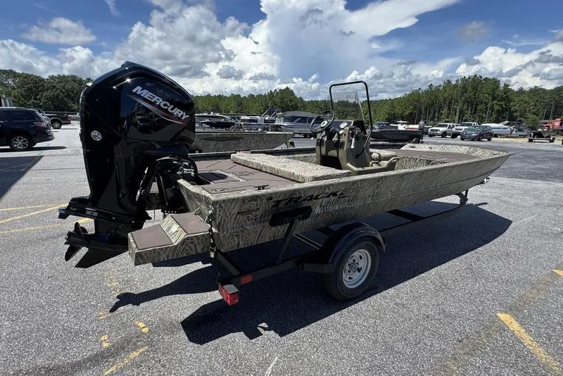 Slide: The Image of 2024 Tracker GRIZZLY® 1860 CC boat with Mercury engine on trailer, parked outdoors. - 10