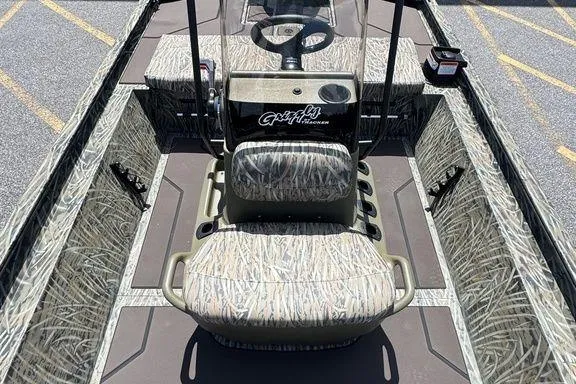 Slide: The Image of 2024 Tracker GRIZZLY® 1860 CC boat interior with camouflage seating and steering console. - 12