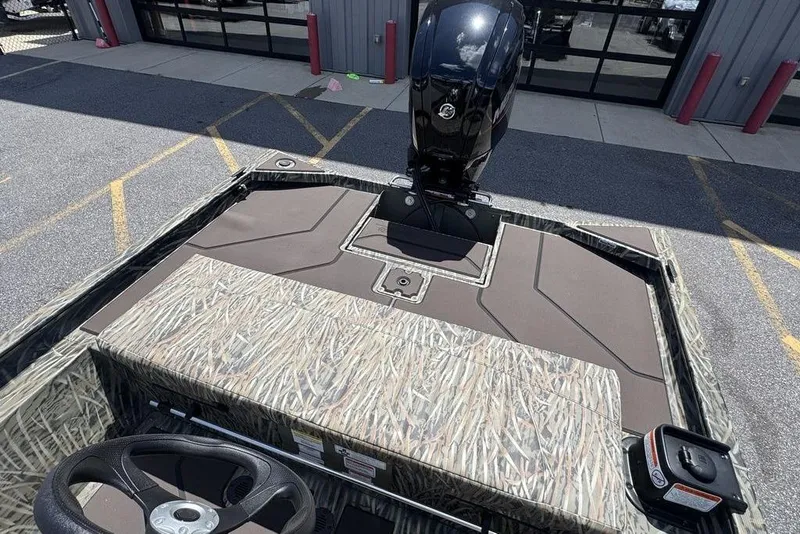 Slide: The Image of 2024 Tracker GRIZZLY® 1860 CC boat with camo design and powerful outboard motor. - 13