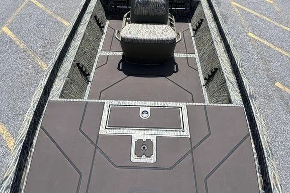 Slide: The Image of 2024 Tracker GRIZZLY® 1860 CC boat interior with camo seating and spacious deck. - 14