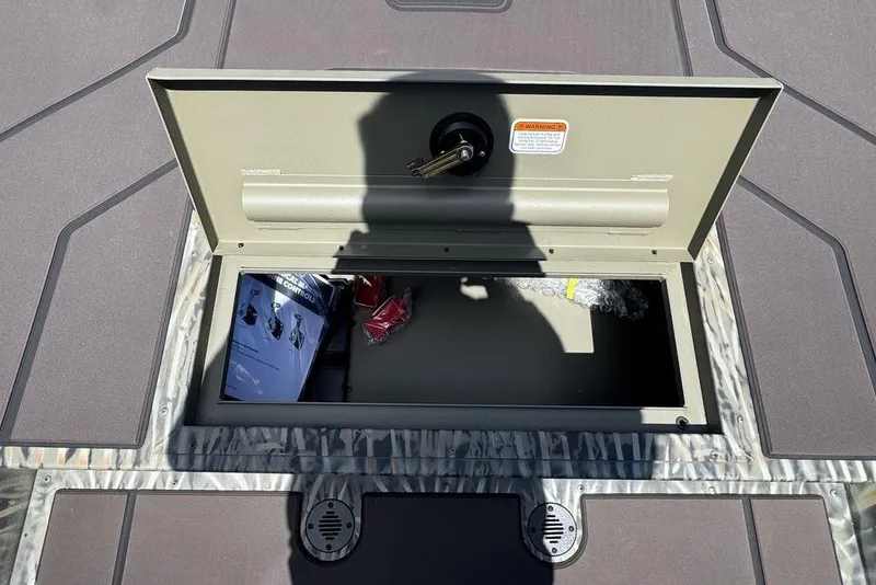 Slide: The Image of Open storage compartment on 2024 Tracker GRIZZLY® 1860 CC boat deck. - 15