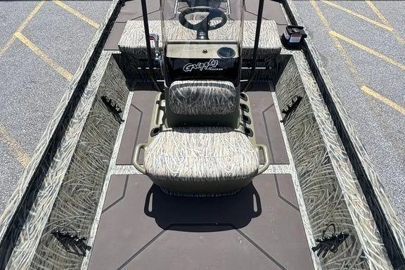 Slide: The Image of 2024 Tracker GRIZZLY® 1860 CC boat interior with camo seating and steering console. - 16