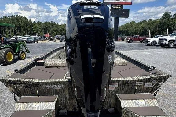 Slide: The Image of 2024 Tracker GRIZZLY® 1860 CC boat with Mercury 90 engine, parked outdoors. - 6