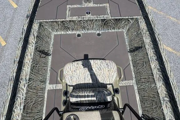 Slide: The Image of 2024 Tracker GRIZZLY® 1860 CC boat interior with camouflage seating and spacious deck. - 9